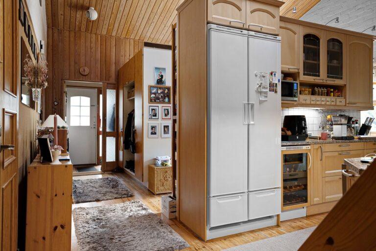 Warm and inviting Scandinavian kitchen with wood elements and modern appliances.